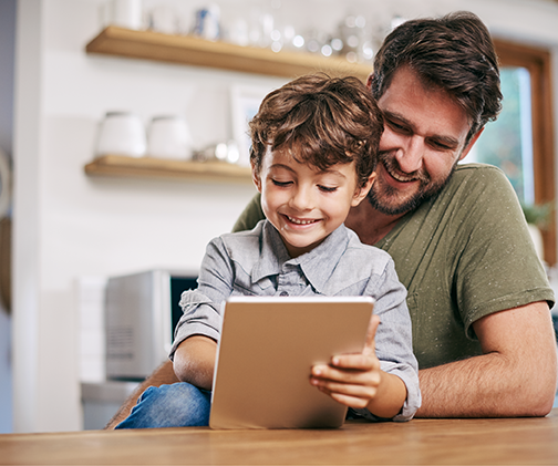 Photo of dad and kid on tablet