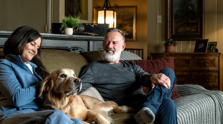 image of a couple sitting on a couch with a dog